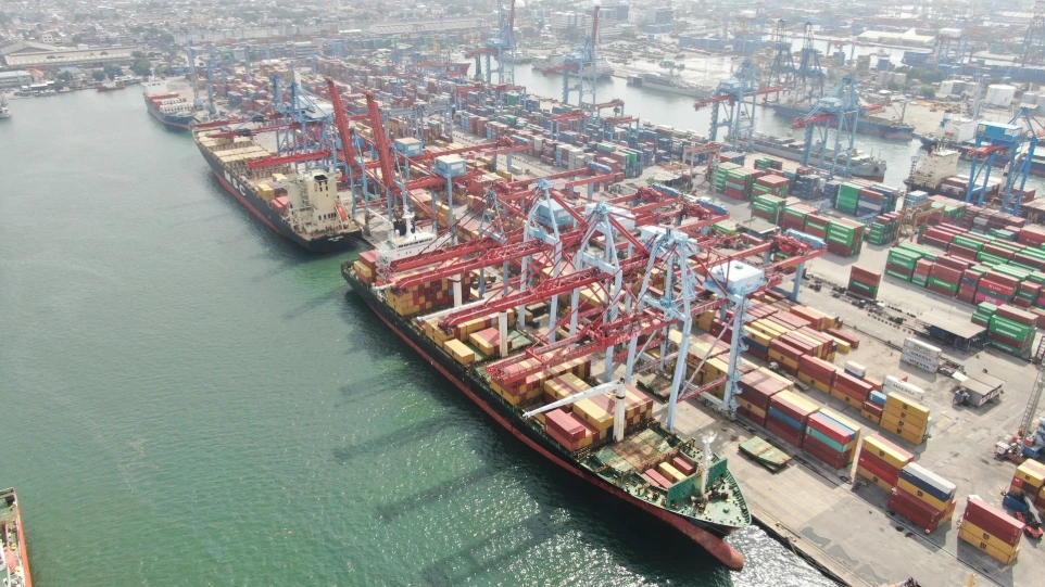 Cargo ships being loaded at a busy port.
